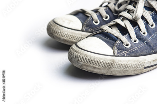 Dirty trainer canvas shoes on white background