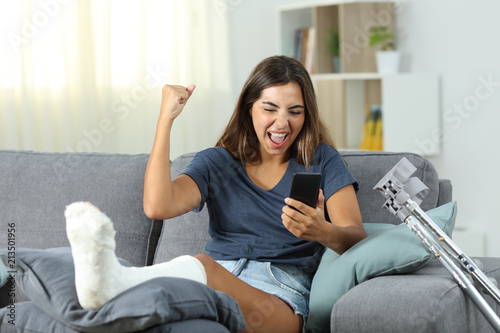 Konstfotografi Excited disabled woman receiving online news