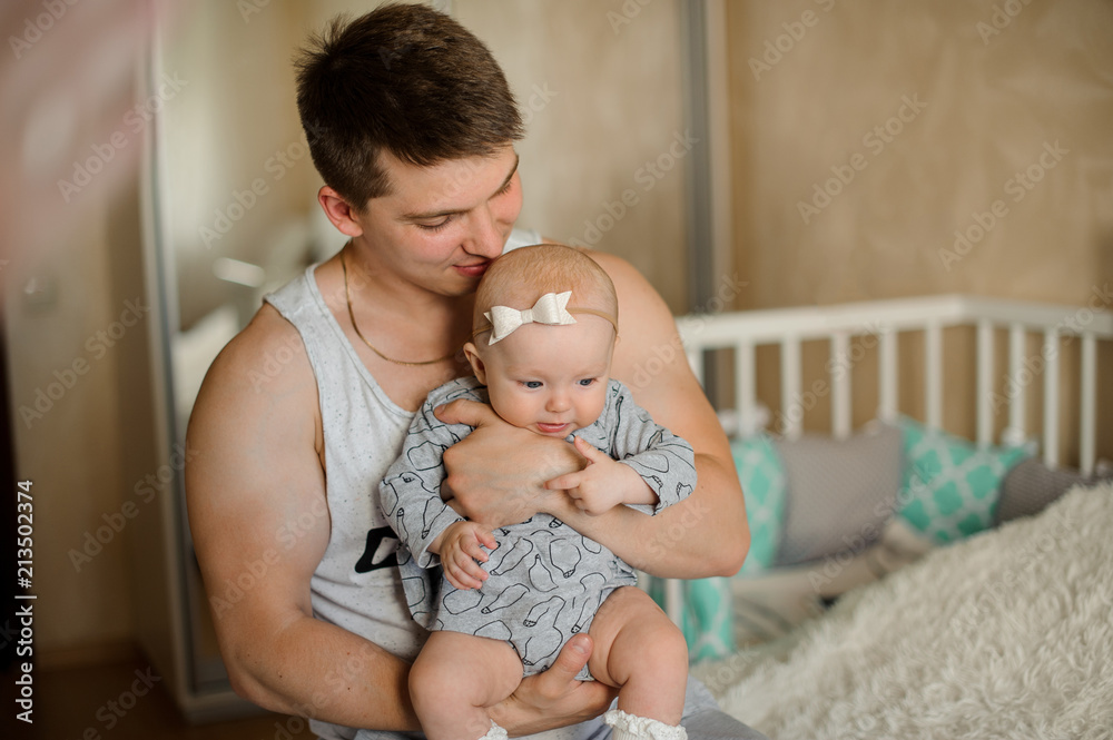 Father holding her little daughter on hands close to face Father holding her little daughter on hands close to face