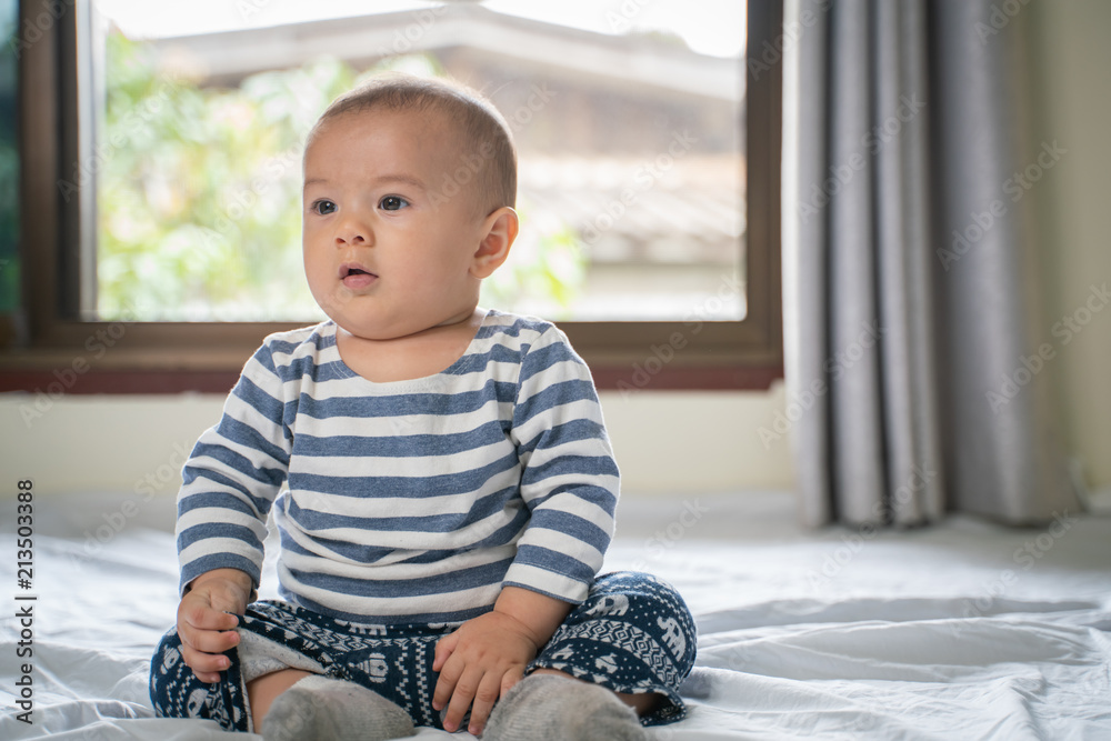 Fototapeta premium The little boy in the bedroom in bed.