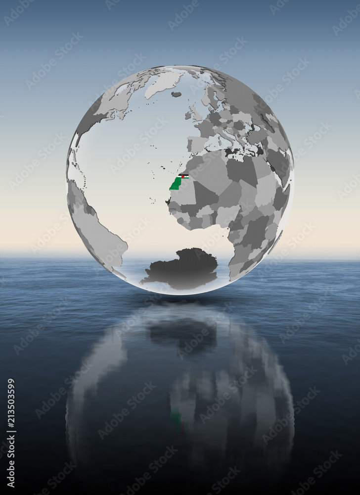 Fototapeta premium Western Sahara on translucent globe above water