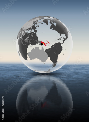 Fototapeta Naklejka Na Ścianę i Meble -  Papua New Guinea on translucent globe above water
