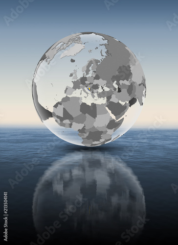 Bosnia and Herzegovina on translucent globe above water