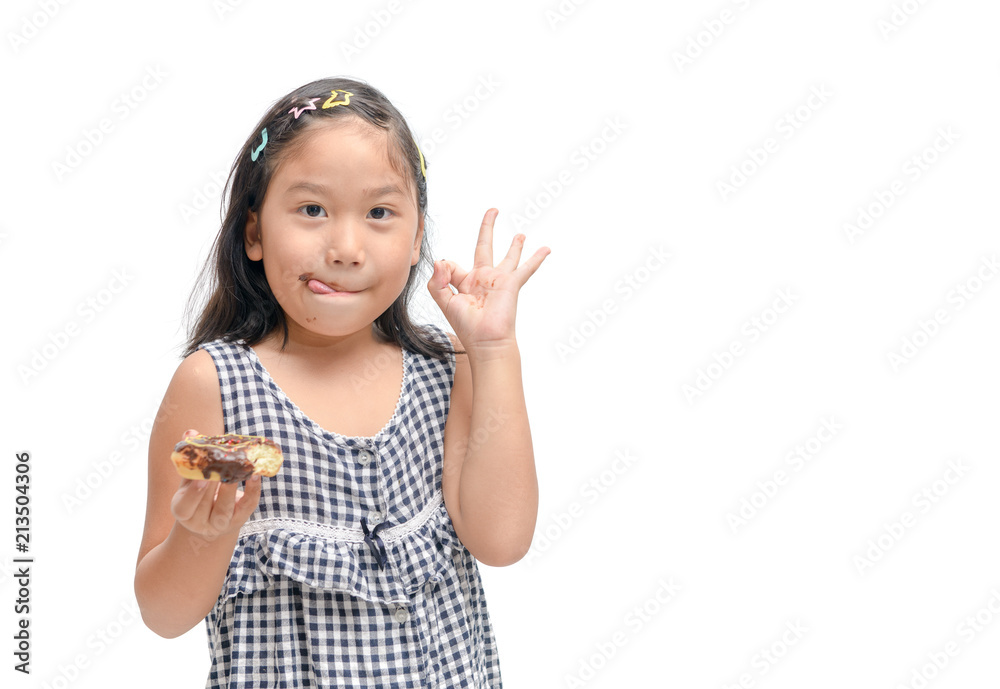 Happy cute girl is eating donut isolated Happy cute girl is eating donut isolated