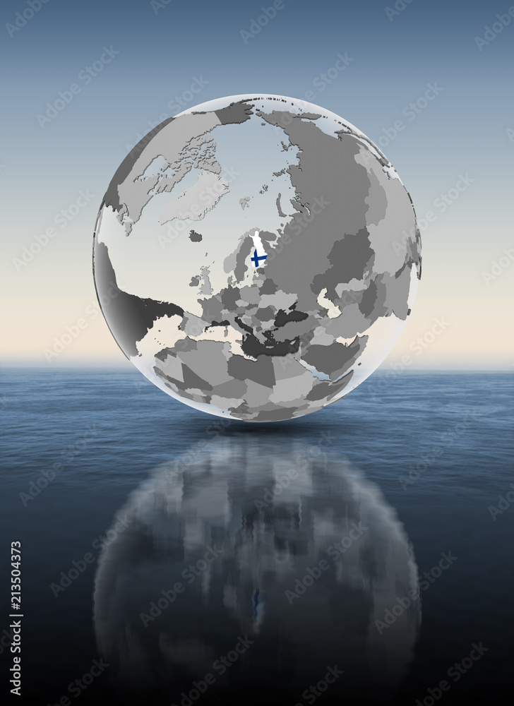 Finland on translucent globe above water Finland on translucent globe above water