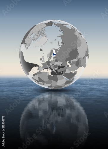 Fototapeta Naklejka Na Ścianę i Meble -  Finland on translucent globe above water