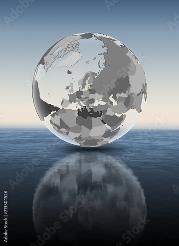 Fototapeta Naklejka Na Ścianę i Meble -  Lithuania on translucent globe above water