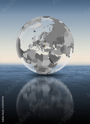 Moldova on translucent globe above water