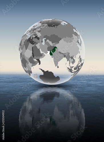 Pakistan on translucent globe above water