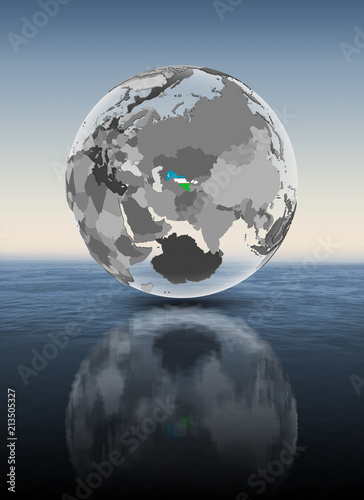 Uzbekistan on translucent globe above water