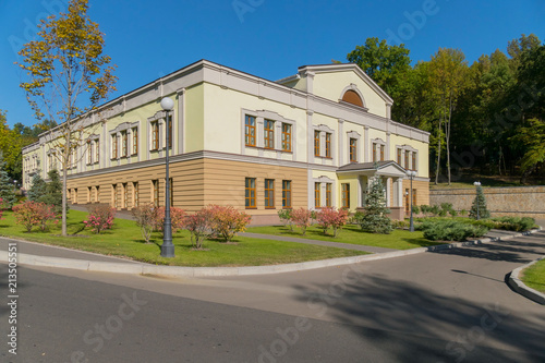 Two-story, two-color school building with a beautiful courtyard with a lawn © adamchuk_leo
