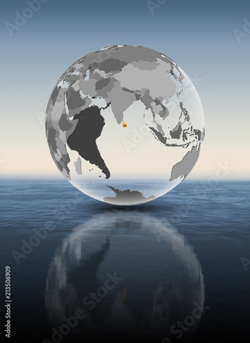 Fototapeta Naklejka Na Ścianę i Meble -  Sri Lanka on translucent globe above water