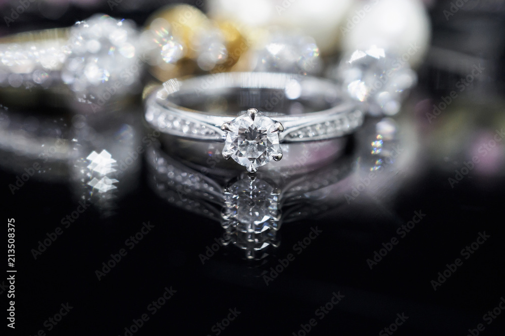 Jewelry diamond rings with reflection on black background Jewelry diamond rings with reflection on black background