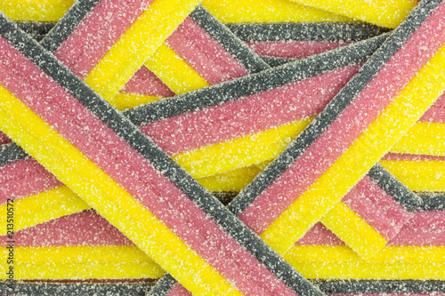 striped gummy candy in black, red and yellow