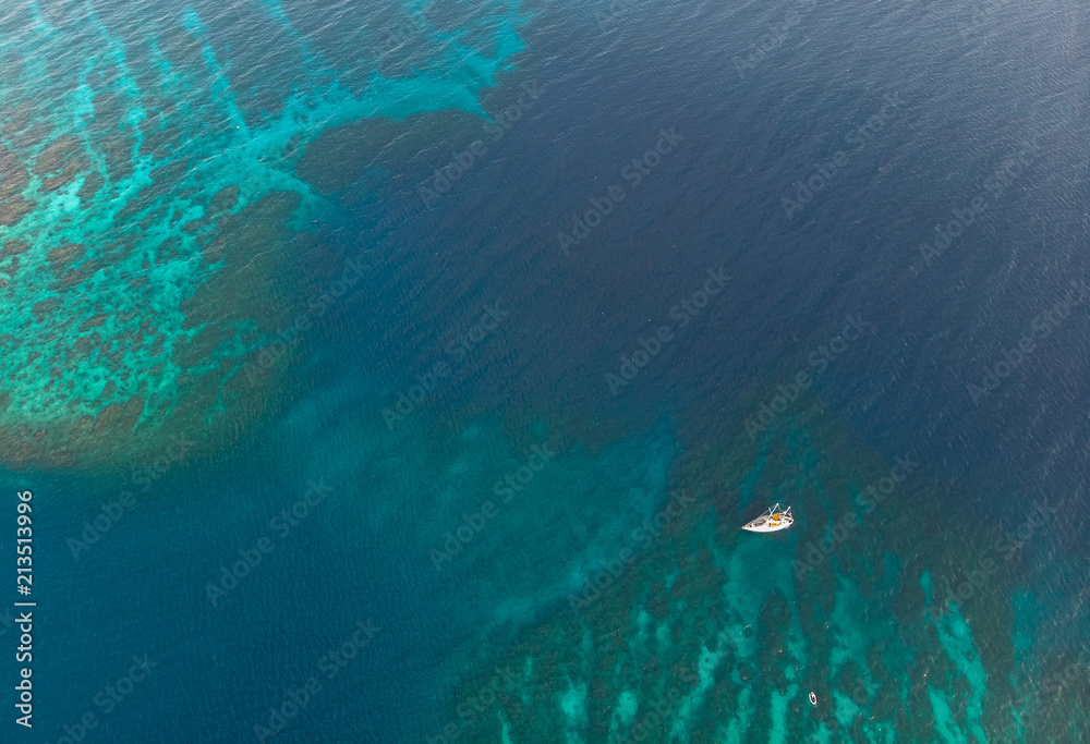 Boat and Dinghy On Caribbean Coral Reef