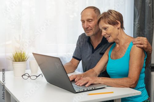 senior couple using laptop computer together at home
