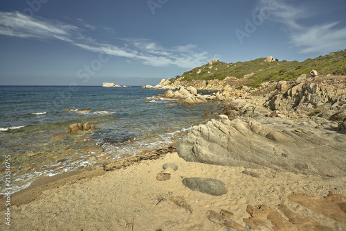 The rocks of the Mediterranean beach at sunset. photo