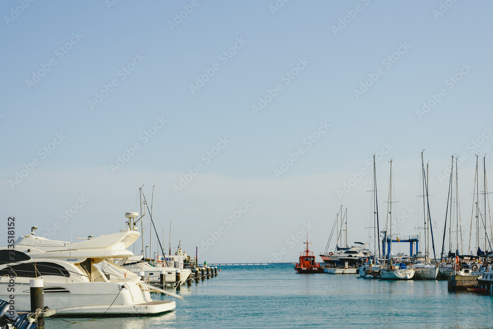 Boats moored at their jetty inside a marina.