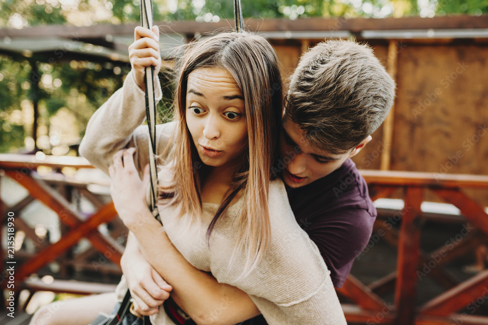 Obraz premium Expressive young couple in zip line harness