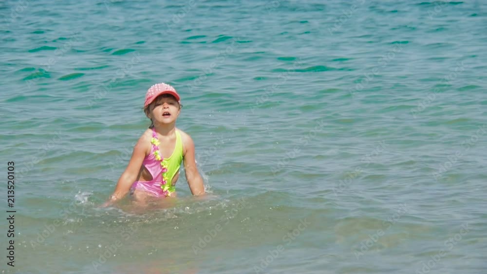 Child at sea. A little girl is splashing into the sea. Child at sea. A little girl is splashing into the sea.