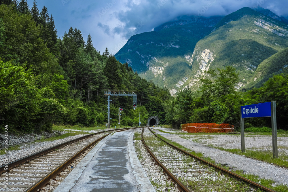 Ospitale, Italy - July, 12, 2018: Alpine landscape with the image of mountain railroad and Ospitale train station