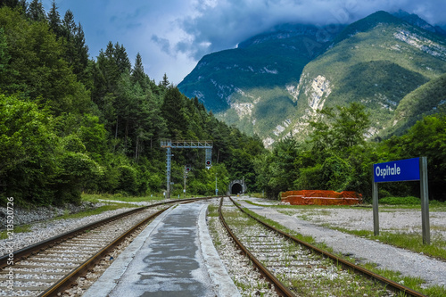 Ospitale, Italy - July, 12, 2018: Alpine landscape with the image of mountain railroad and Ospitale train station