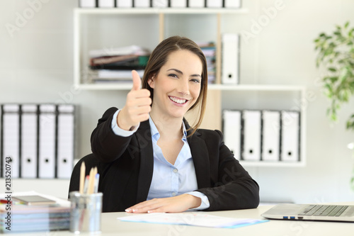 Proud office worker posing with thumbs up