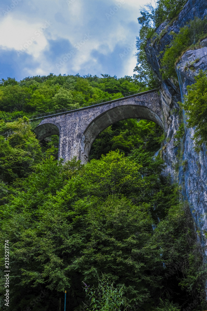 Alpine landscape with the image of arch bridge