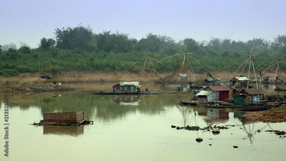 Lake landscape with houseboats and chinese fishing nets in the morning Lake landscape with houseboats and chinese fishing nets in the morning