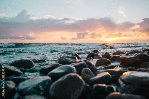 Sunset on the beach - dark wet stones © Mikkel H. Petersen
