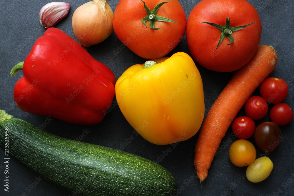 Variety of fresh vegetables on dark board, top view Variety of fresh vegetables on dark board, top view