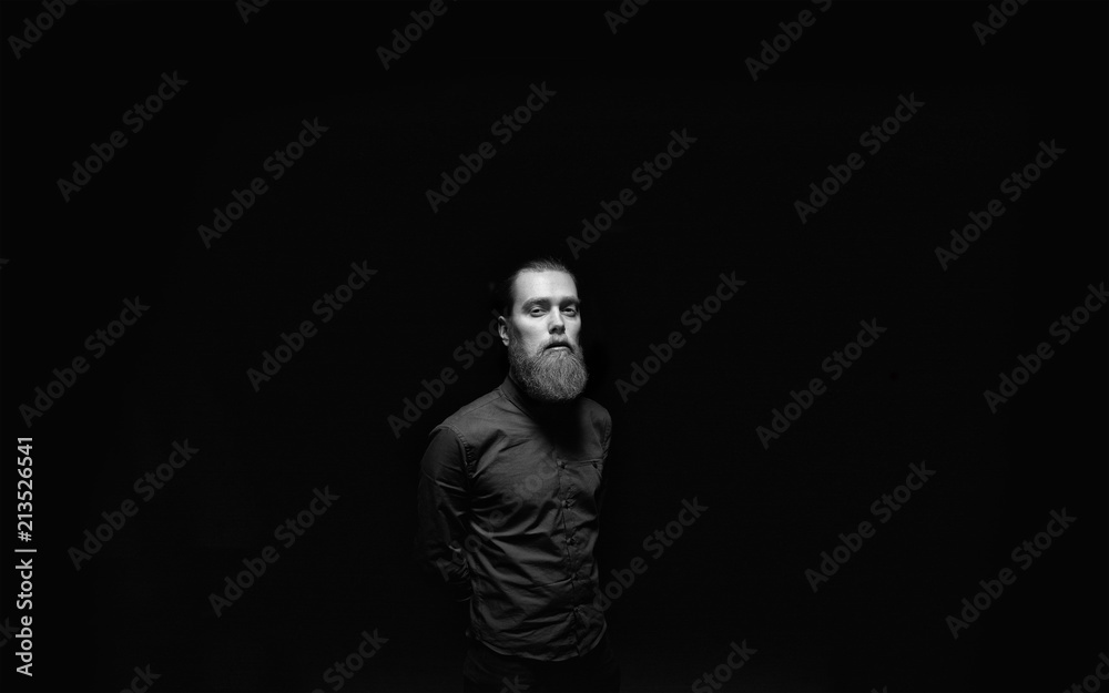 Obraz premium A male standing in the black background. 