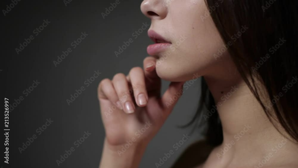 Brunette is touching her lips Brunette is touching her lips
