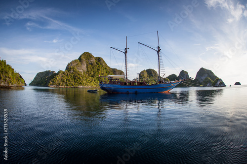 Pinisi Schooner in Peaceful Lagoon, Wayag, Raja Ampat photo