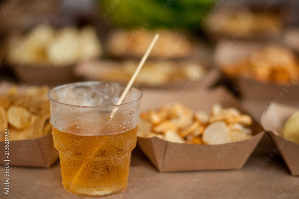 Cool drink of cider, beer, lemonade, in a glass on wooden rustic snacks background. Alcoholic drink concept. Сlose-up, space for text, soft selective focus Cool drink of cider, beer, lemonade, in a glass on wooden rustic snacks background. Alcoholic drink concept. Сlose-up, space for text, soft selective focus