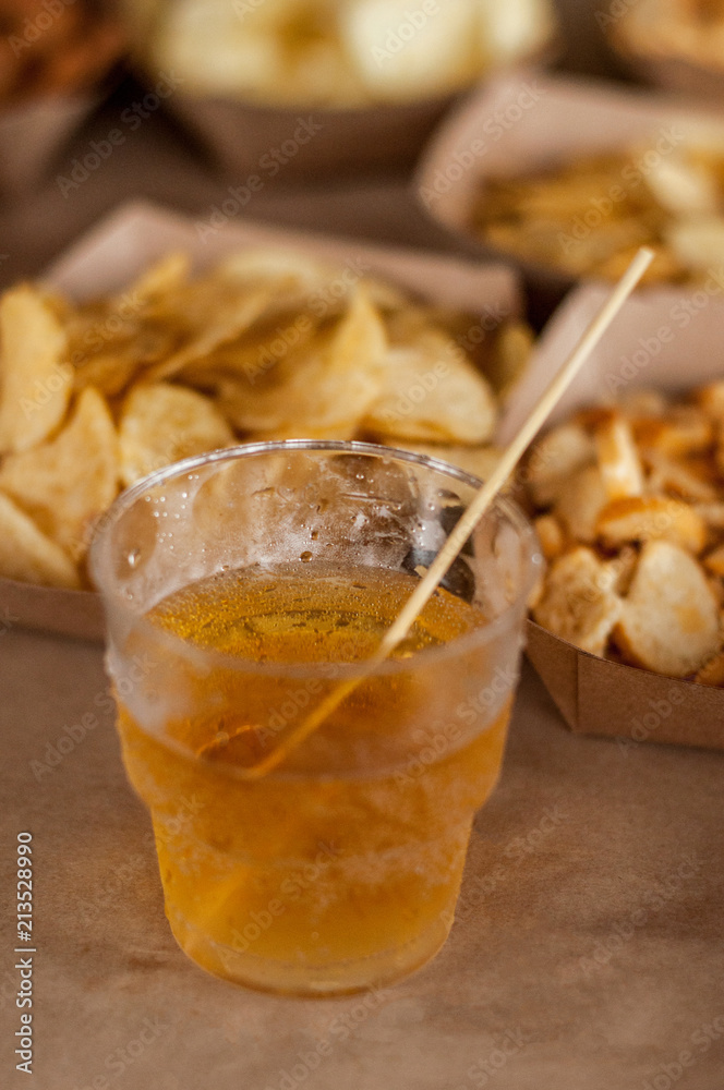 Cool drink of cider, beer, lemonade, in a glass on wooden rustic snacks background. Alcoholic drink concept. Сlose-up, space for text, soft selective focus Cool drink of cider, beer, lemonade, in a glass on wooden rustic snacks background. Alcoholic drink concept. Сlose-up, space for text, soft selective focus