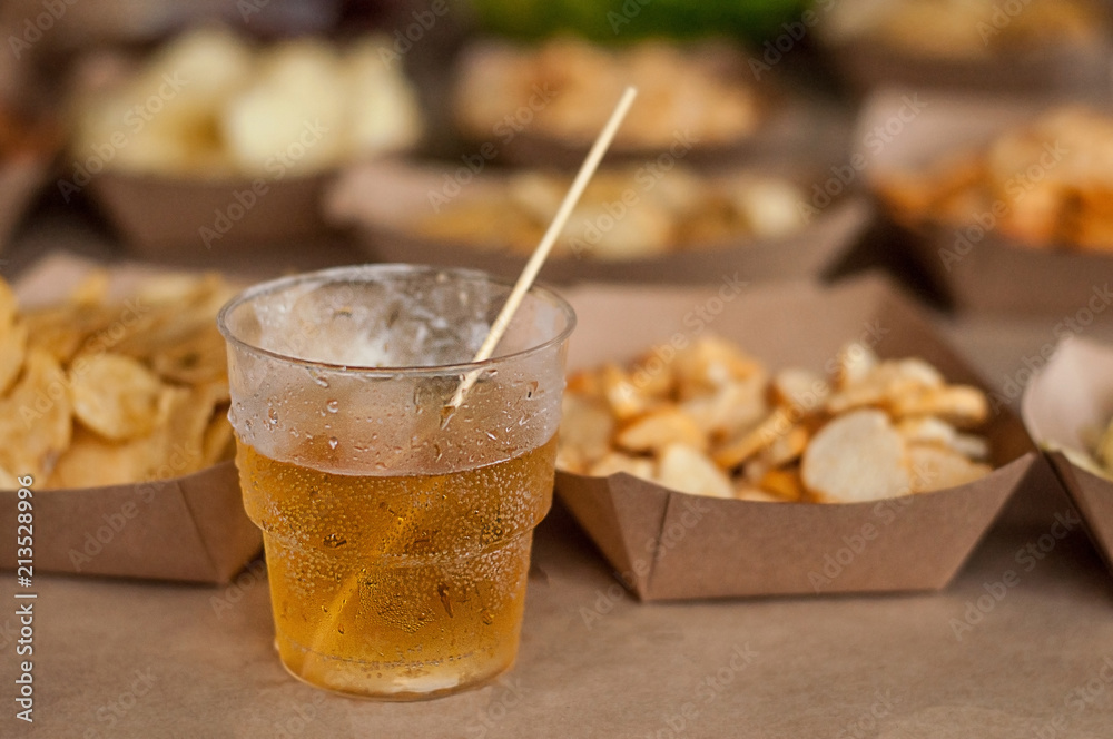Cool drink of cider, beer, lemonade, in a glass on wooden rustic snacks background. Alcoholic drink concept. Сlose-up, space for text, soft selective focus Cool drink of cider, beer, lemonade, in a glass on wooden rustic snacks background. Alcoholic drink concept. Сlose-up, space for text, soft selective focus