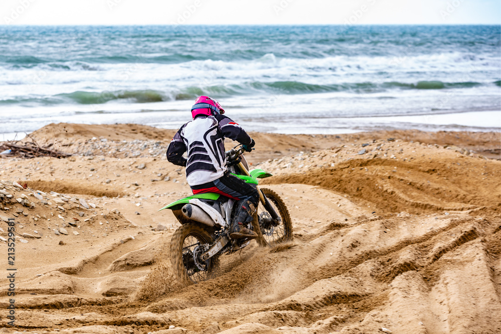 Obraz premium Professional Motocross Motorcycle Rider Drives Over the Road Track.