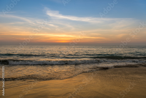 Waves on the beach  sunset  cloudy sky.