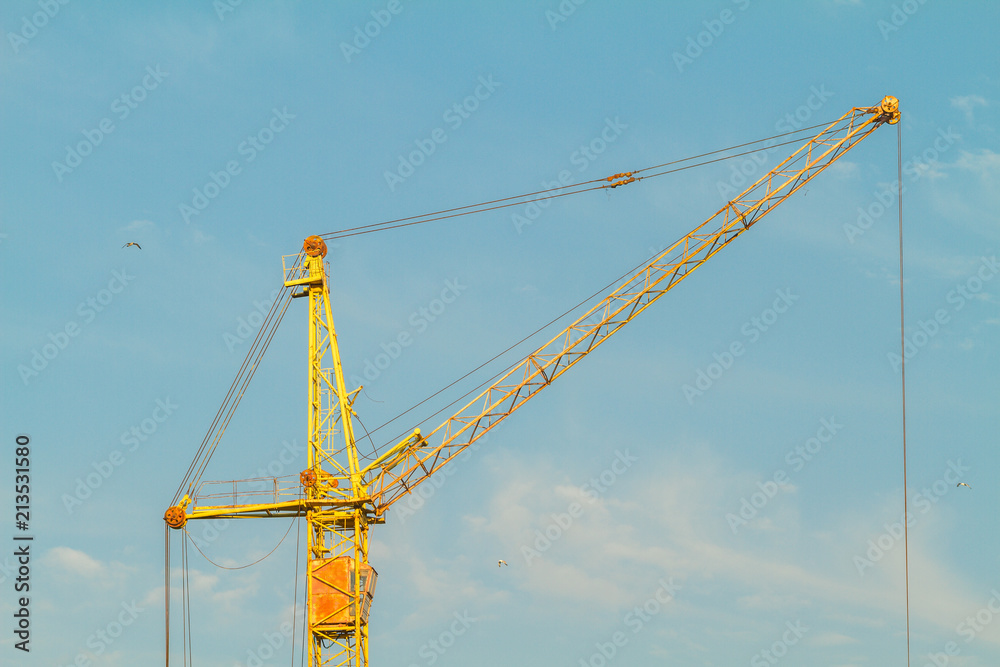 construction yellow crane on blue sky background