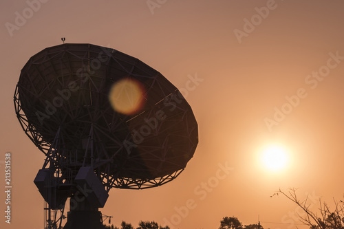 Fototapeta Naklejka Na Ścianę i Meble -  Satellite control antenna, sunset orange sky
