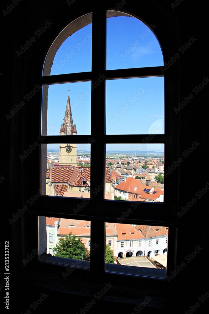 Fototapeta premium Evangelist Cathedral and red roofs top view through window
