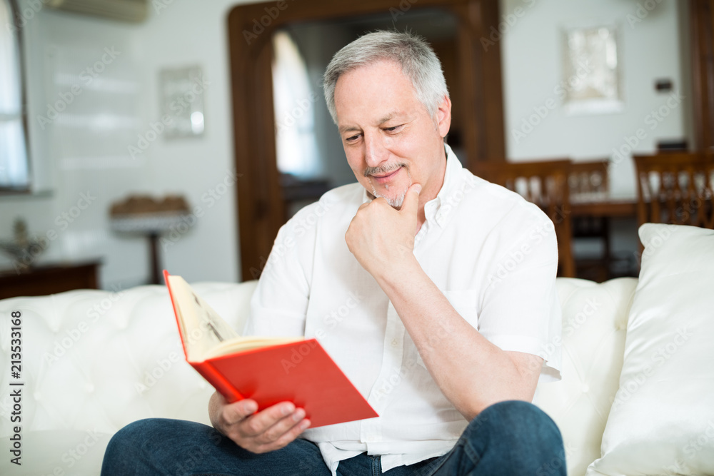 Happy mature man reading a book Happy mature man reading a book