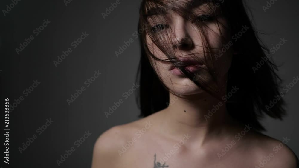 Asian girl is standing with face covered with hair Asian girl is standing with face covered with hair