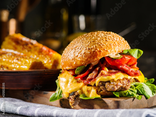 Homemade juicy burger with beef, bacon, cheese and bulgarian pepper. Street food, fast food