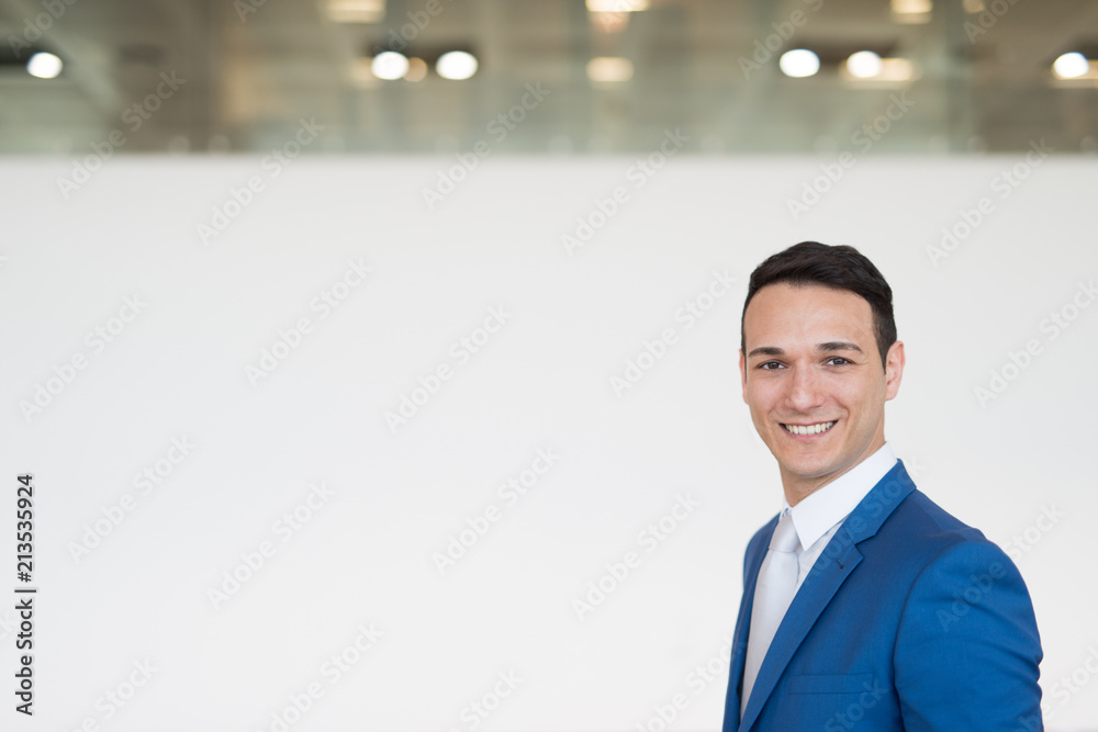 Smiling businessman, empty banner in the background Smiling businessman, empty banner in the background