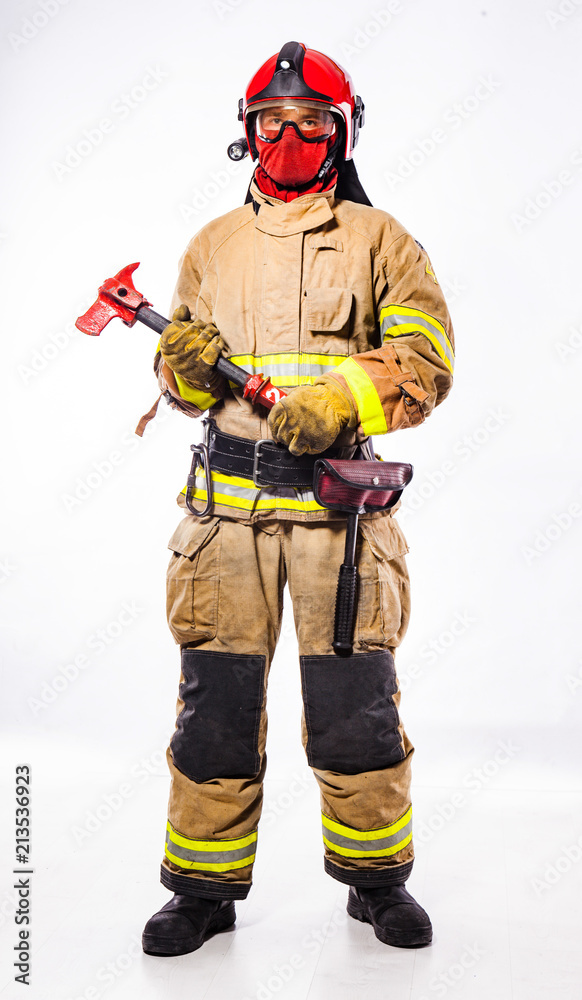 Man in suit of firefighter holding ax Man in suit of firefighter holding ax