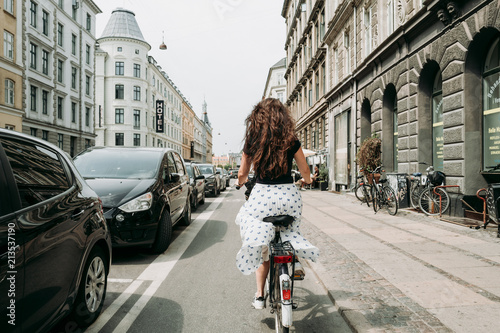 Woman in skirt on a bike in the streets of Copenhagen photo