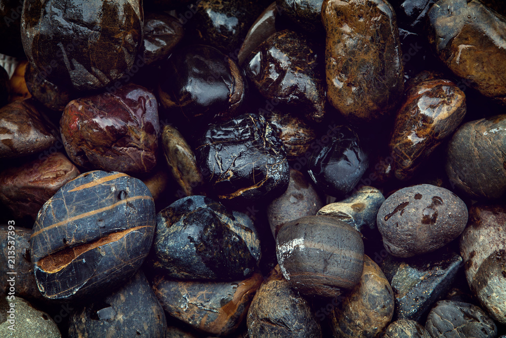 Closeup natural dark stone wet background texture.