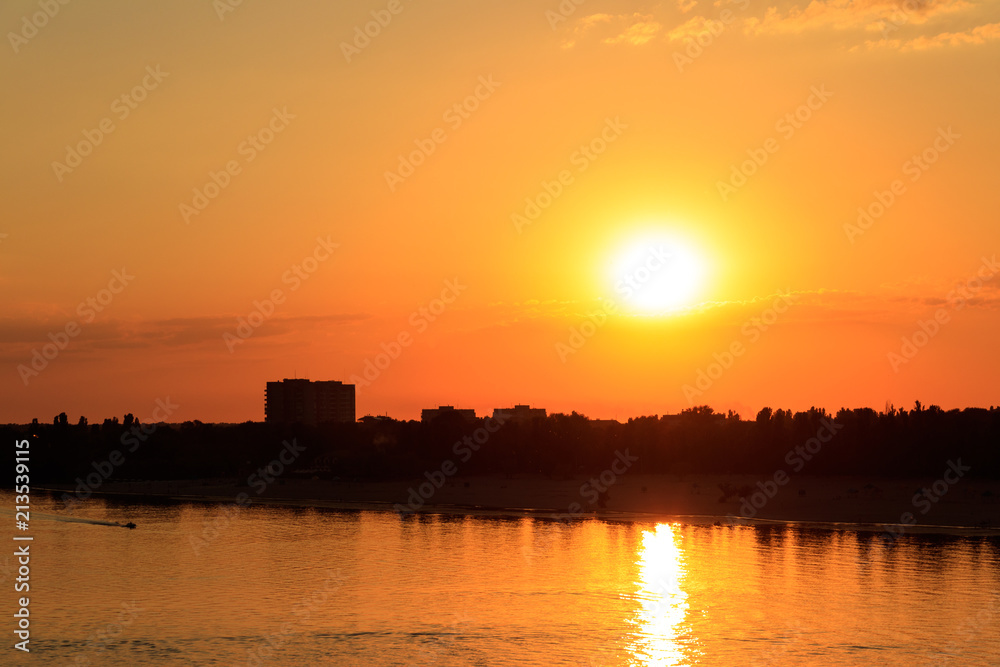 Orange sunset over a river Dnieper in Kremenchug city, Ukraine